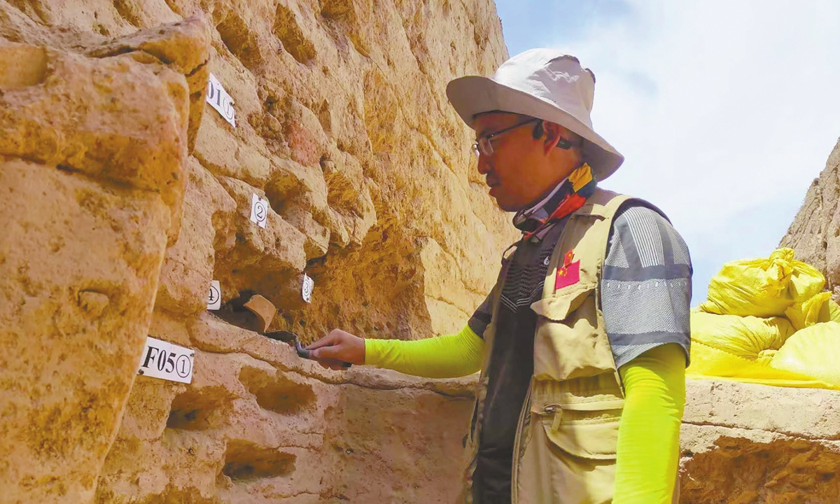 Archaeologist Tang Yunpeng collects samples at the Chinortepa ruins site.