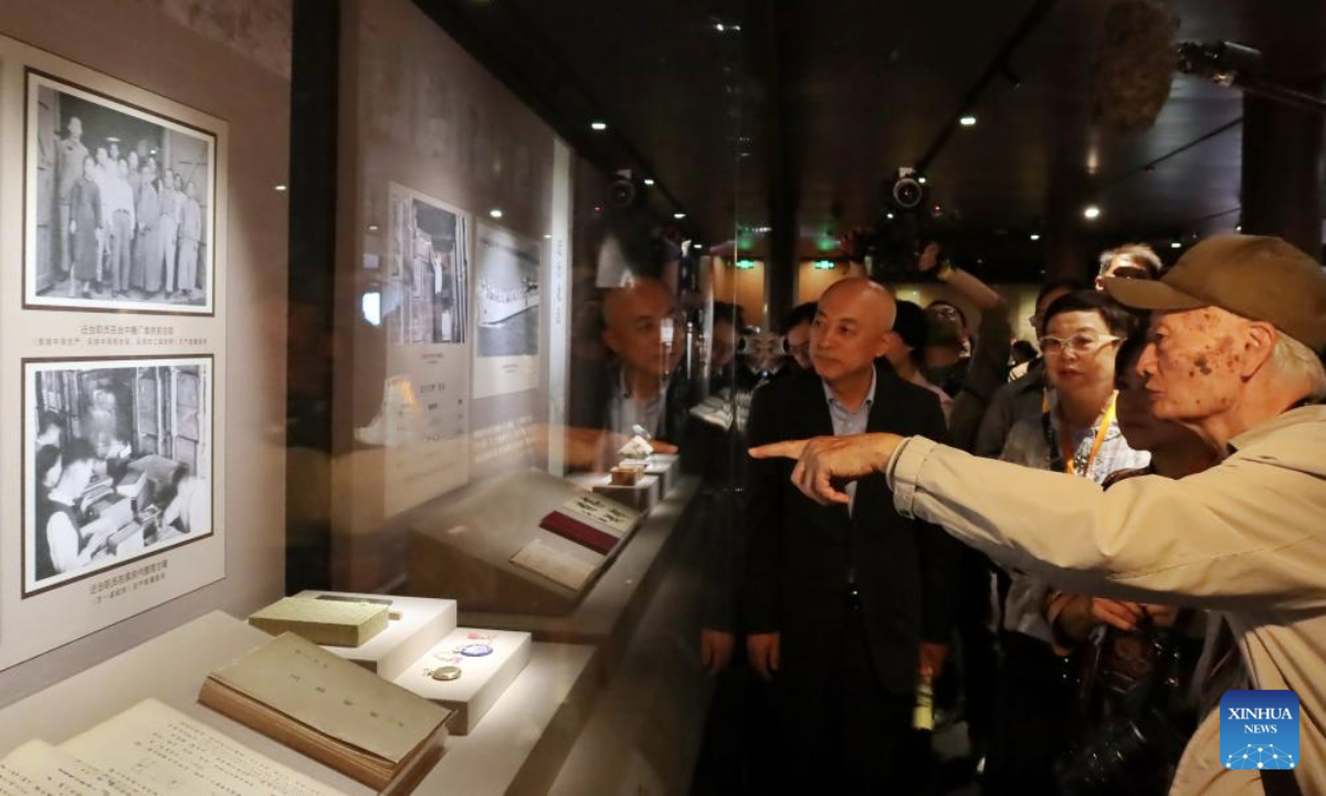 Chuang Ling (1st R), the son of Chuang Yan, former vice curator of the Palace Museum in Taipei, introduces the exhibits at an exhibition commemorating the miraculous evacuation of the Palace Museum's collection during Chinese People's War of Resistance against Japanese Aggression more than 80 years ago, in Beijing, capital of China, Sept. 30, 2025. (Xinhua)