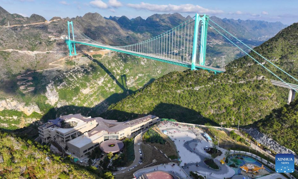 This aerial drone photo taken on Nov. 6, 2025 shows the Huajiang Grand Canyon Bridge and the nearby Yundu service area in southwest China's Guizhou Province. The Huajiang Grand Canyon Bridge, soaring 625 meters above the Beipan River in Guizhou's mountainous terrain, is the world's highest bridge. The nearby Yundu service area features a comprehensive complex that integrates bridge viewing, sports experiences and other tourism services. (Xinhua/Ou Dongqu)
