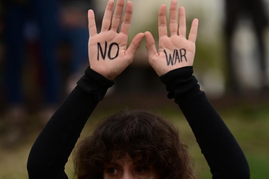 A demonstrator raises hands painted with No War slogan during a rally to protest against U.S.-Israeli attacks on Iran and demand an end to all acts of war in Tel Aviv, Israel, March 14, 2026. (Tomer Neuberg/JINI via Xinhua)